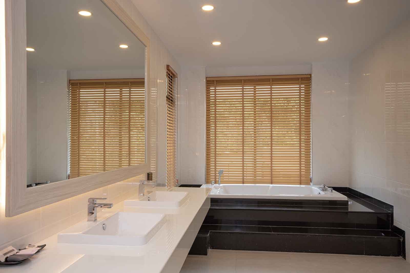 Twin basins and sunken bath in the master bathroom